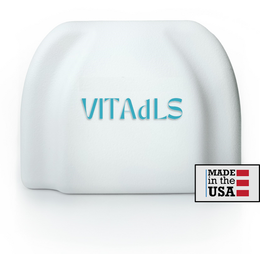 Image of a VITAdLS Gateway - a palm-sized white, squarish device. 