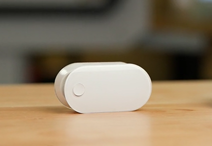 White pulse oximeter sits on a table.